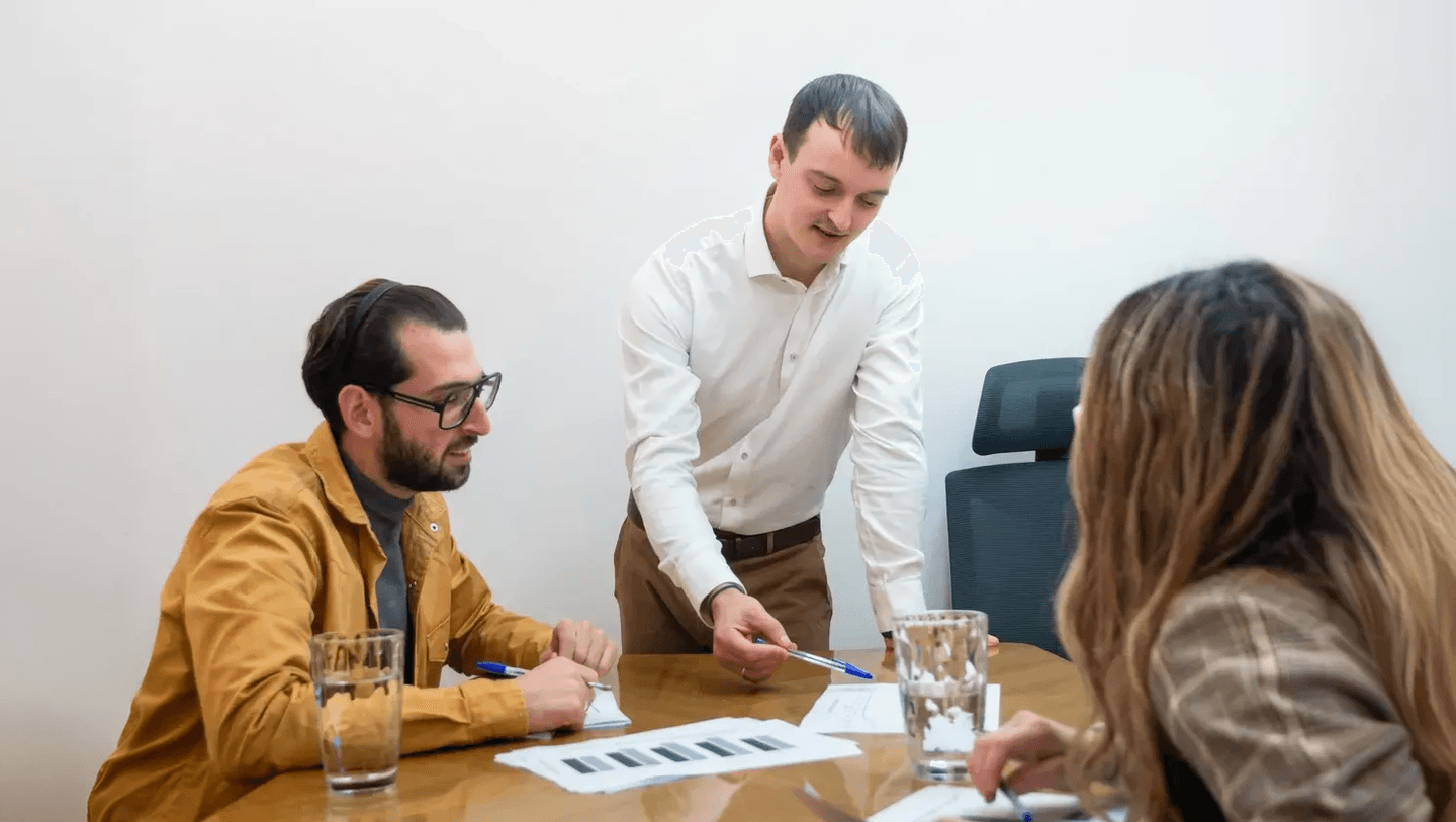Tom Salley coaching a small group around a meeting table